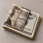 Folded US bills held securely by a personalized engraved money clip