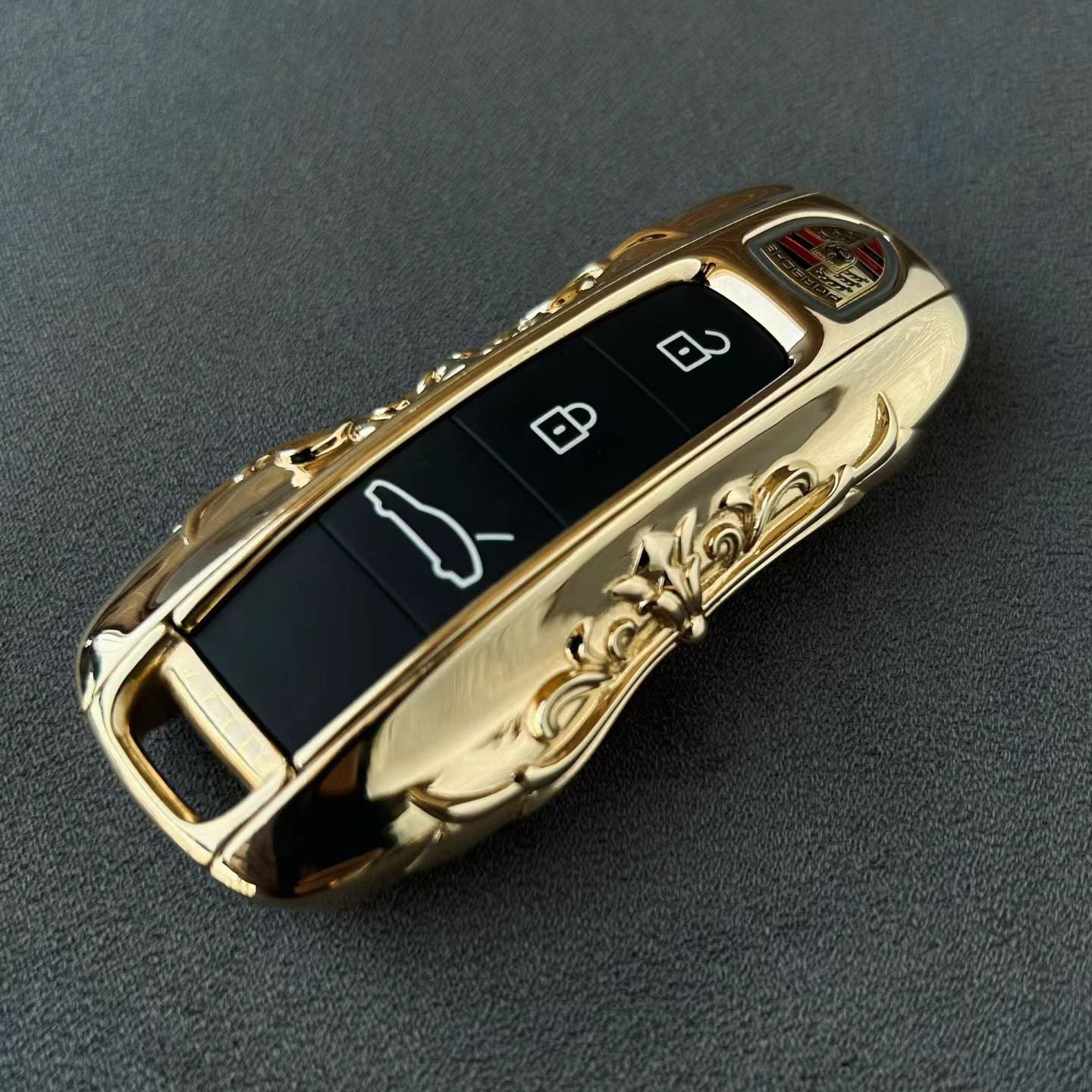 Custom IGNIS ARGENTUM 18K Gold key case with hand-engraved ornate scrollwork, showcasing exceptional refinement and substantial presence, precision-machined to factory remote