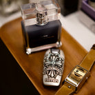 Custom Ferrari Key Case, displayed beside fragrance bottle and watch