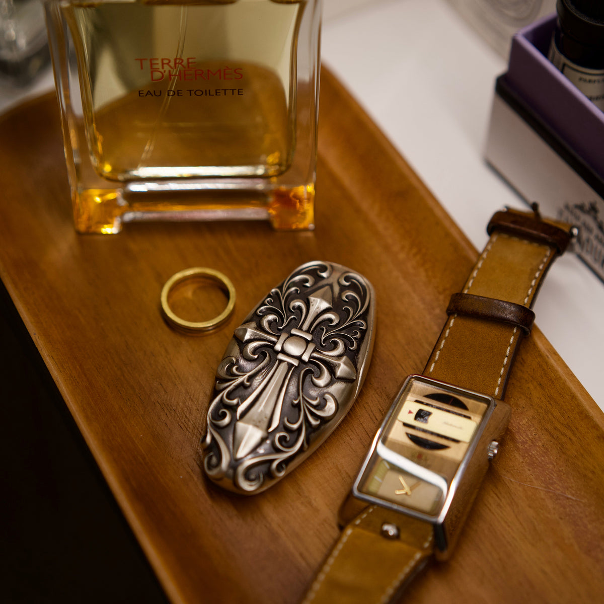 Custom McLaren Key Case, displayed beside fragrance bottle and watch
