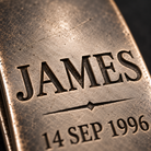 Macro close-up of deep recessed engraving on an antique silver money clip