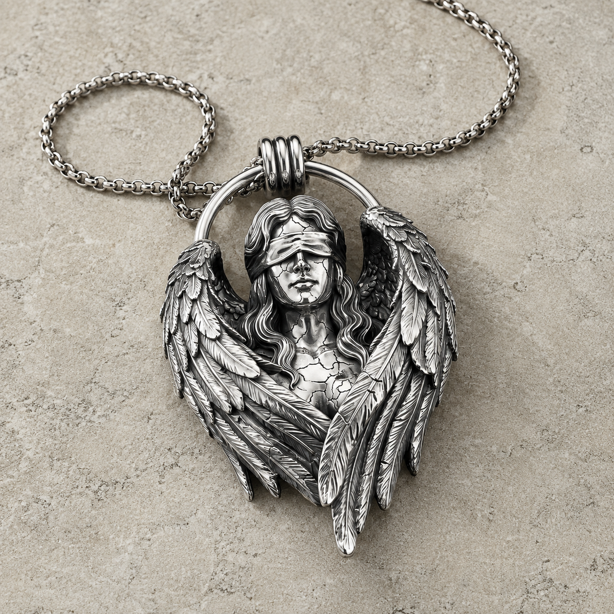 Fallen Angel Blindfolded Pendant, displayed on a dark surface
