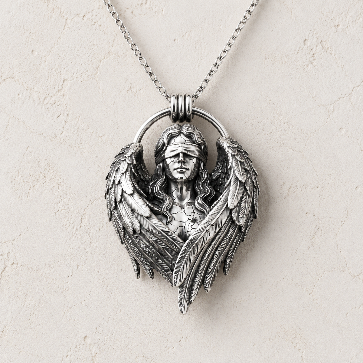 Fallen Angel Blindfolded Pendant, held for scale