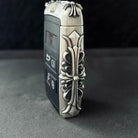 Close-up of intricate floral scrollwork engraving on handcrafted solid silver surface