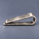 Side profile of one-piece spring money clip with moderate functional opening