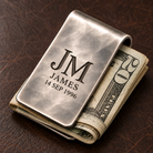 Personalized hand-planished money clip securely holding folded cash