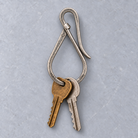 Patina Key Hook with two styling keys and illustrative lower-loop engraving, naturally partly hidden by the keys