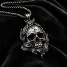Memento Mori Skull & Feather Pendant, held for scale