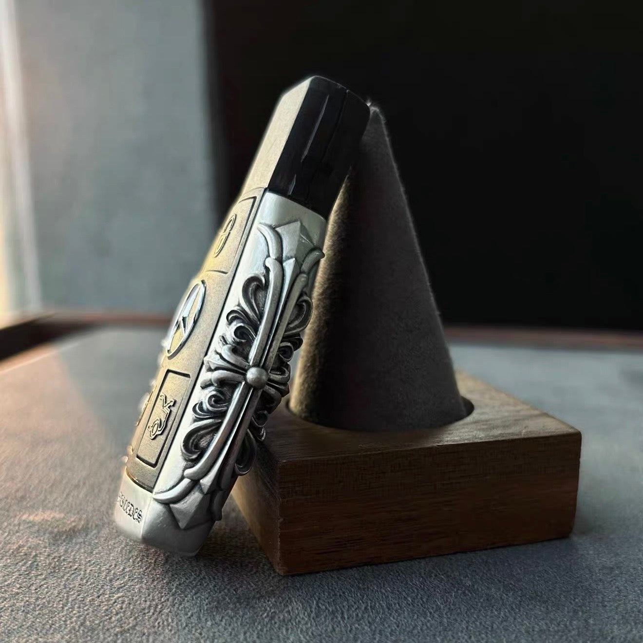 Mercedes classic oval key case standing presentation on wooden stand showcasing substantial build and continuous oval engraving pattern