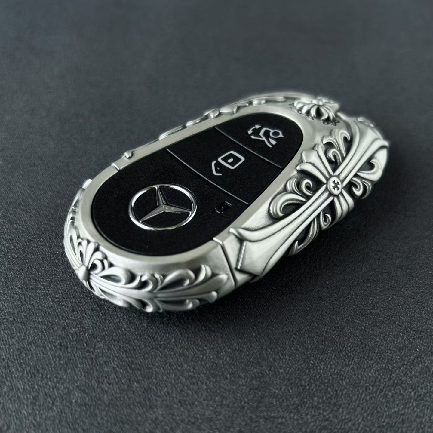 Handmade silver key case for Mercedes back view showing brand engraving and metal texture with intentional weight and density