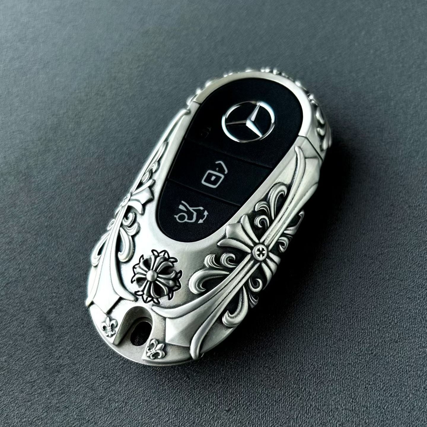 Mercedes, Rounded Capsule, Nickel Silver, front view, floral relief, emblem