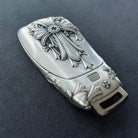 Mercedes slim rectangle key case back view showing hanging loop and hand-finished engraving details with intentional weight and density