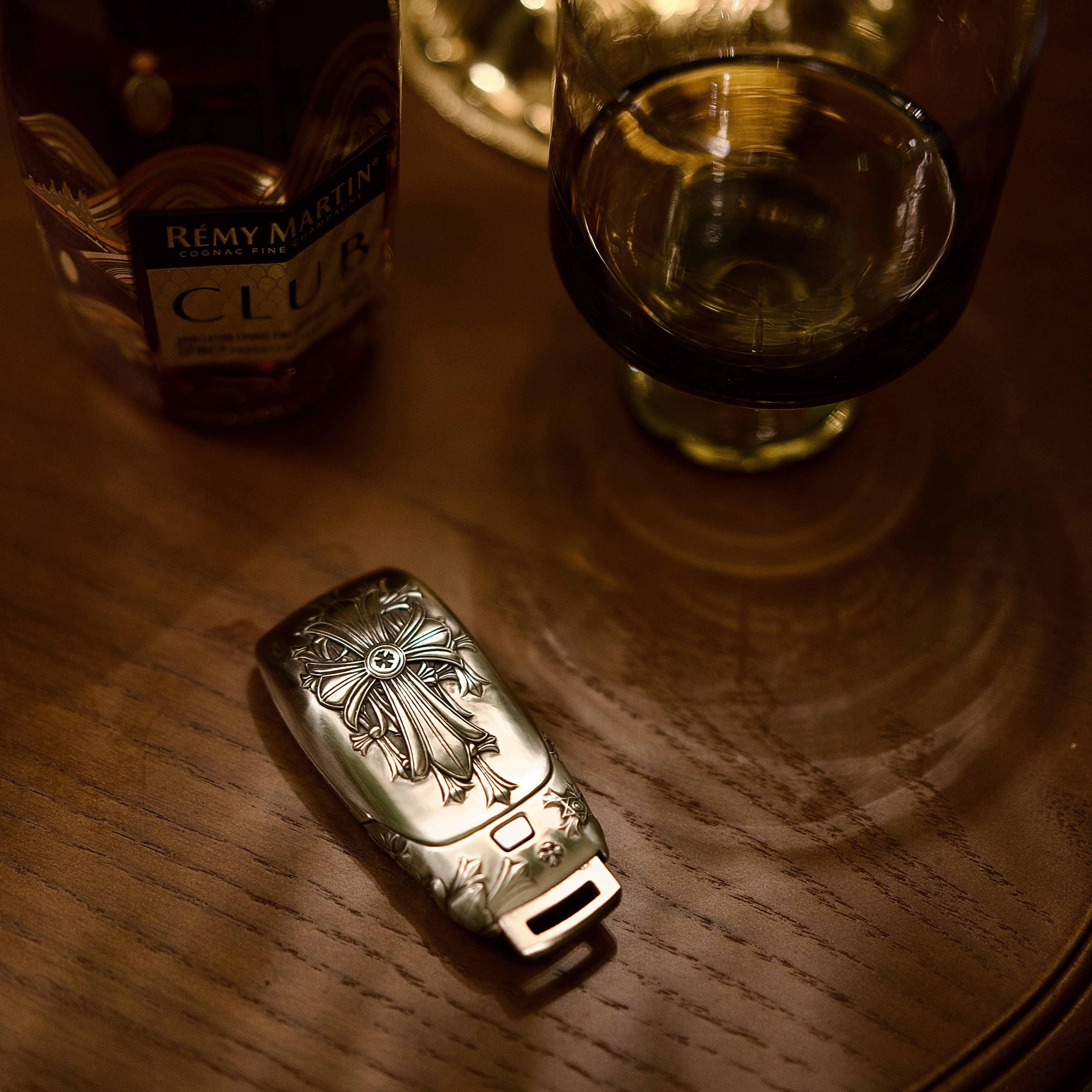 Mercedes slim rectangle key case diagonal side profile leaning on wooden block showing weighty precision and continuous engraving pattern