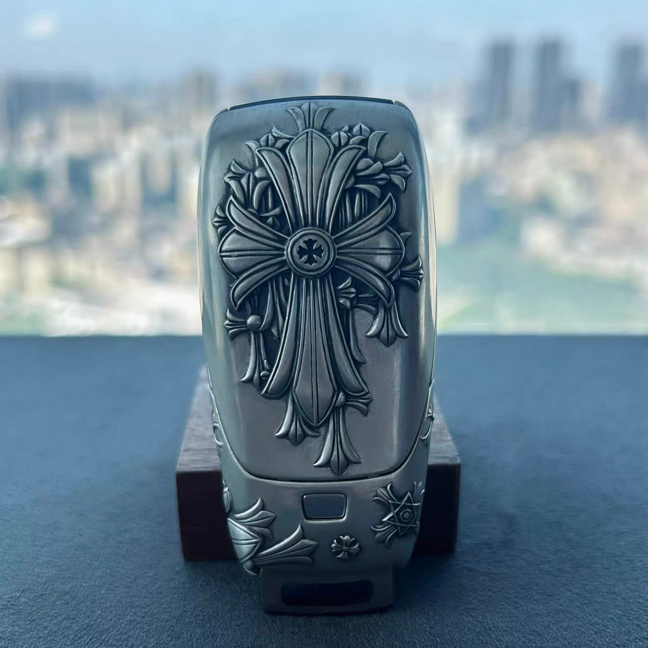 IGNIS ARGENTUM Mercedes key case standing upright on wooden block against city skyline background showcasing understated luxury and intentional weight