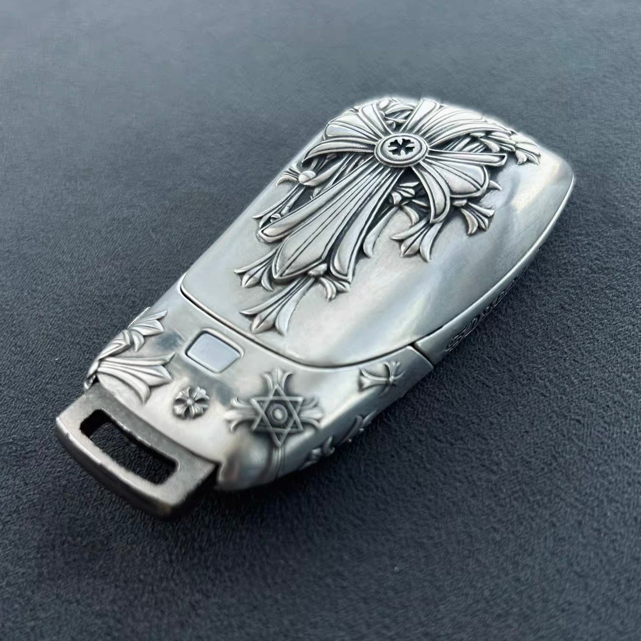 Mercedes slim rectangle key case standing presentation on wooden block solid blue background highlighting substantial build and refined patina