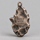 Hephaestus charm, personalized back engraving example: BUILT WITH CARE