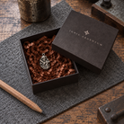 Hephaestus MYTHOS charm — IGNIS ARGENTUM gift box styling; design visualization