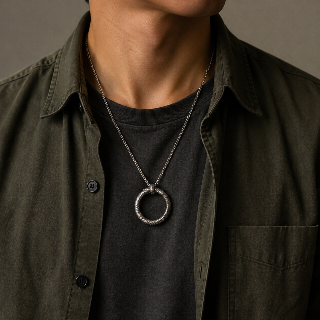 Ouroboros Serpent Circle Pendant, held for scale