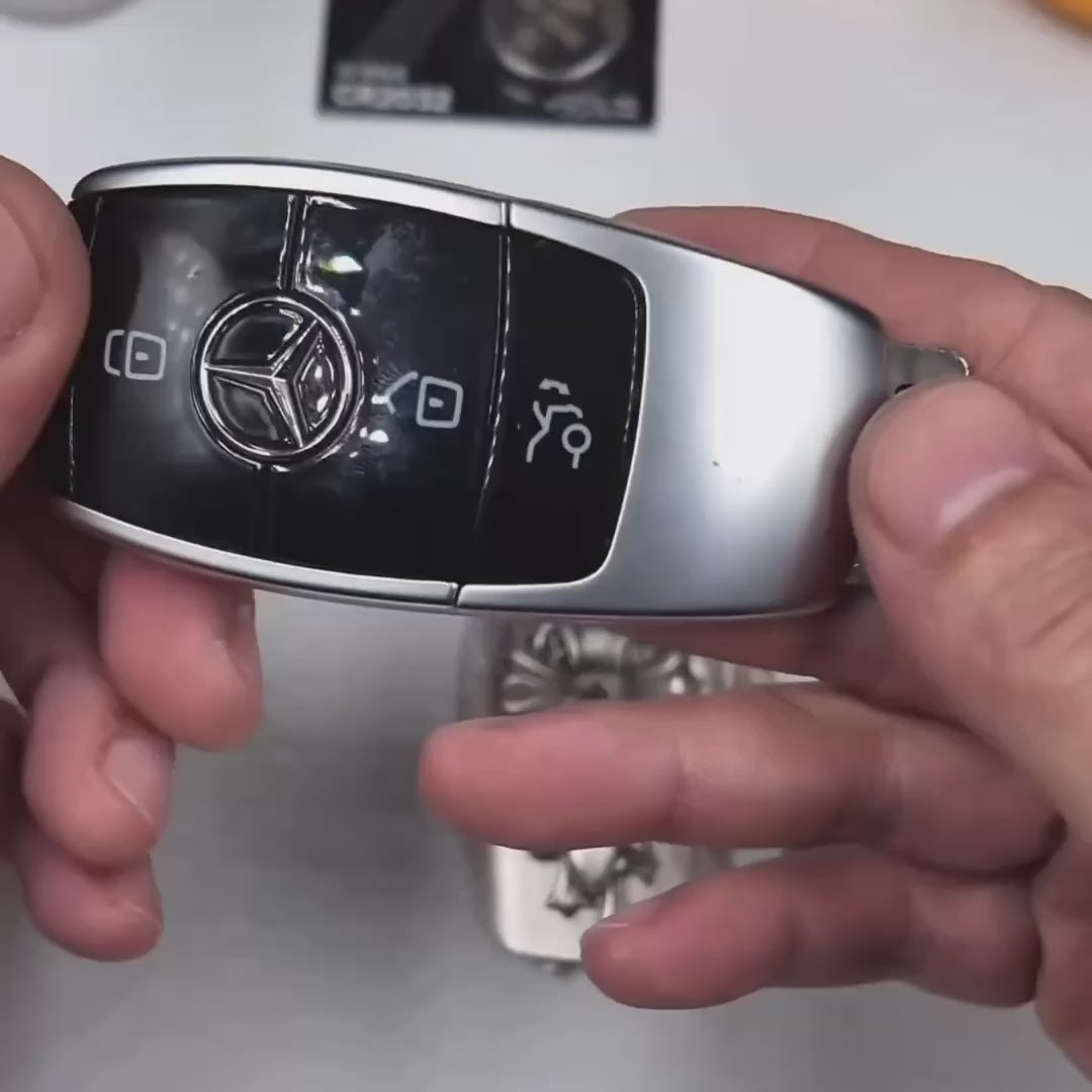 Installation demonstration of IGNIS ARGENTUM sterling silver key case for Mercedes slim rectangle key fob — precision-machined to match factory remote, showcasing seamless integration, refined finish, and straightforward assembly with included tool.