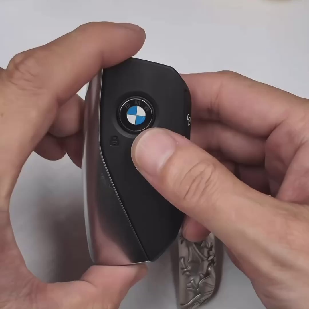 Handcrafted 925 Sterling Silver BMW key case — rotating view showing faceted blade motif engraving, precision fitment, and substantial weight. Compatible with 3/5/7 Series/X3/X5/X7.