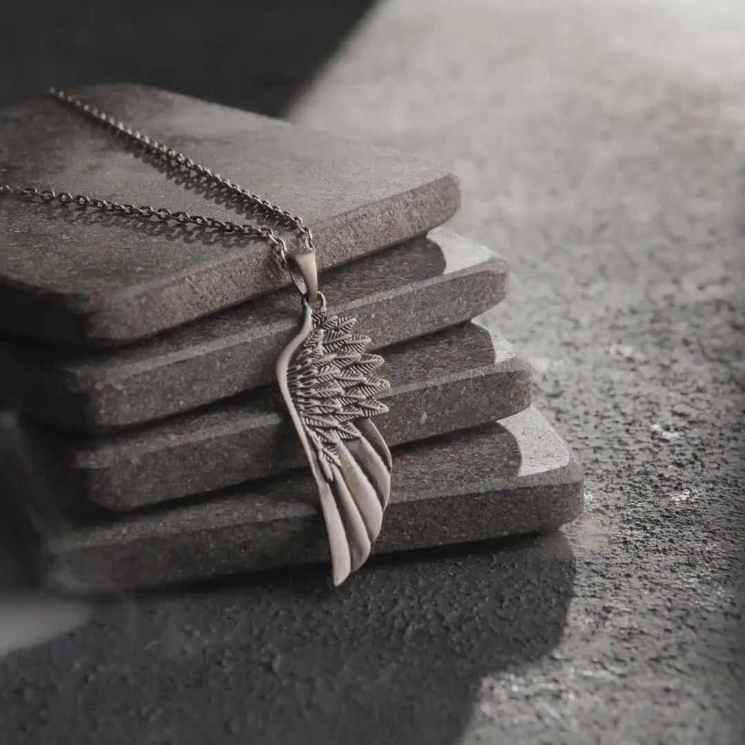 Video showing an angel wing sterling silver pendant worn as a necklace