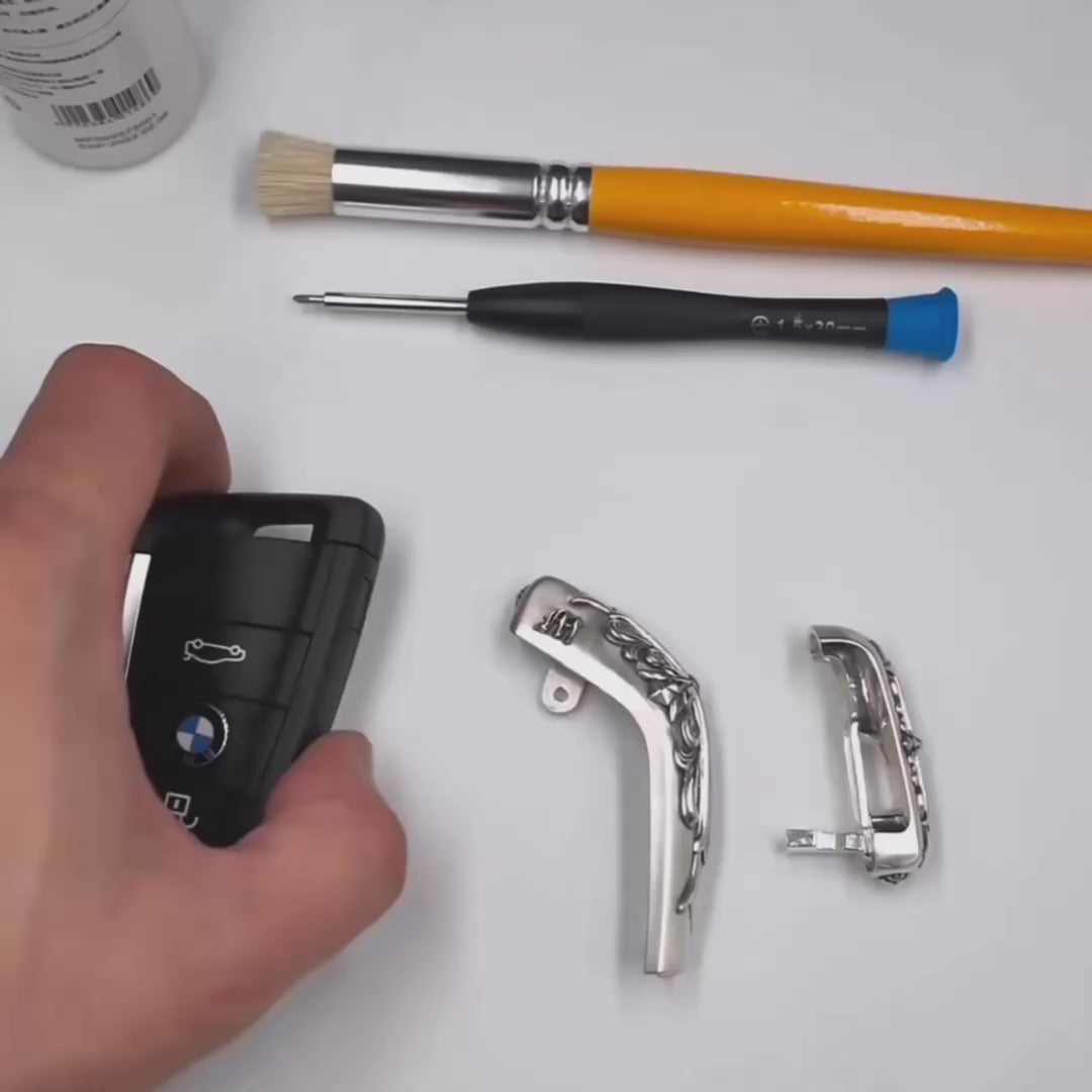 Installation demonstration of IGNIS ARGENTUM sterling silver key case for BMW slim edge key fob — precision-machined to match factory remote, showcasing seamless integration, refined finish, and straightforward assembly with included tool.