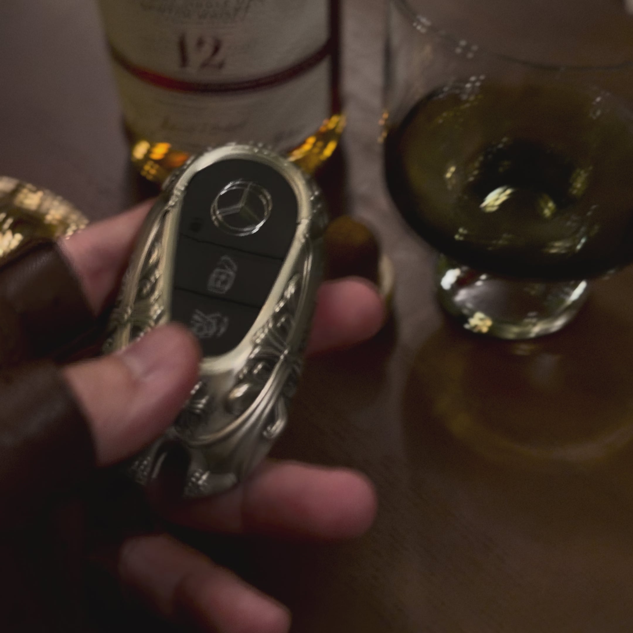 Mercedes rounded capsule key case handheld perspective showing substantial hand-feel and considerable presence in daily carry