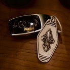 Royal Fleur Personalized Silver Keychain, front view beside a car key