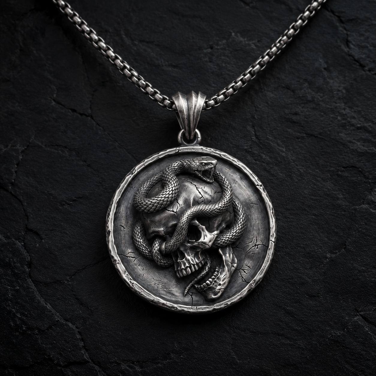 Serpent Skull Medallion Pendant, displayed on a dark surface