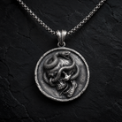 Serpent Skull Medallion Pendant, displayed on a dark surface