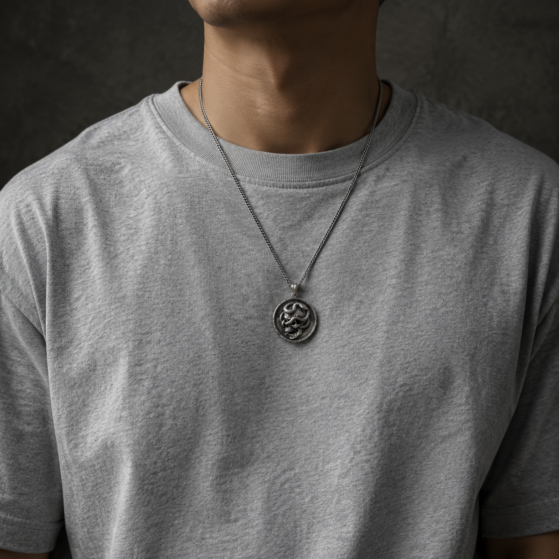 Serpent Skull Medallion Pendant, held for scale