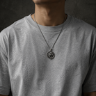 Serpent Skull Medallion Pendant, held for scale