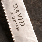 Close-up of two-line name and birth date engraving