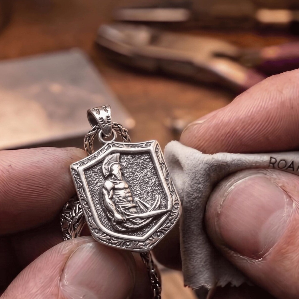 Spartan Shield & Sword Pendant, held for scale