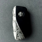 Hand holding precision-crafted BMW key case, demonstrating substantial weight