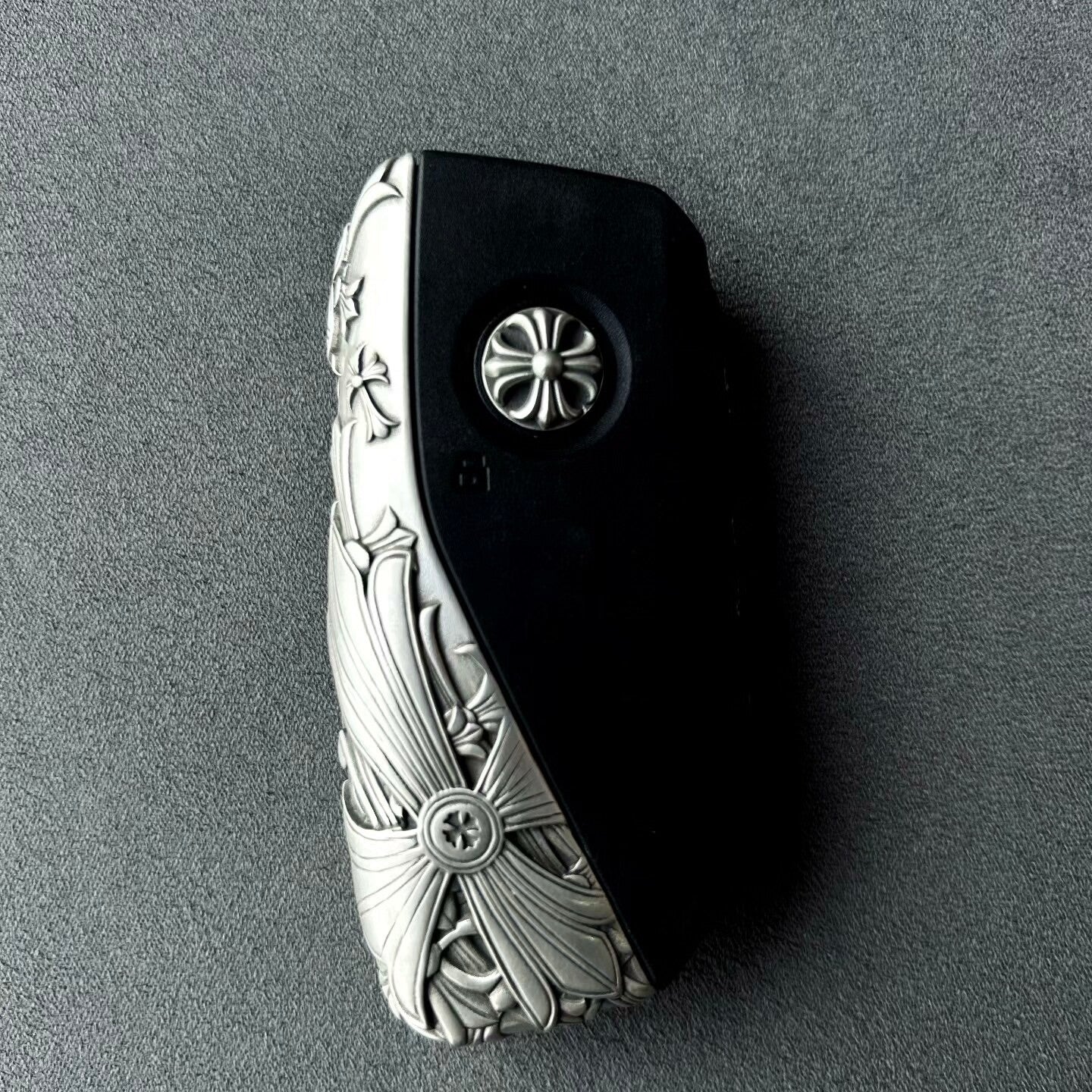 Hand holding precision-crafted BMW key case, demonstrating substantial weight