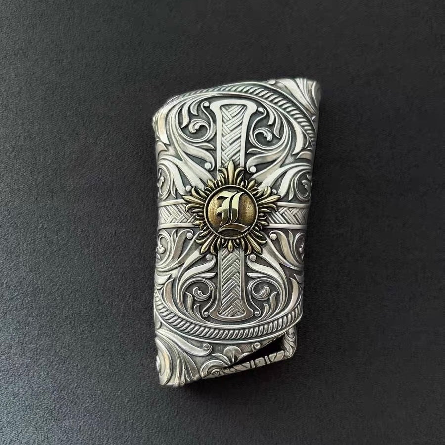 Hand holding precision-crafted Lexus key case, demonstrating substantial 85g weight