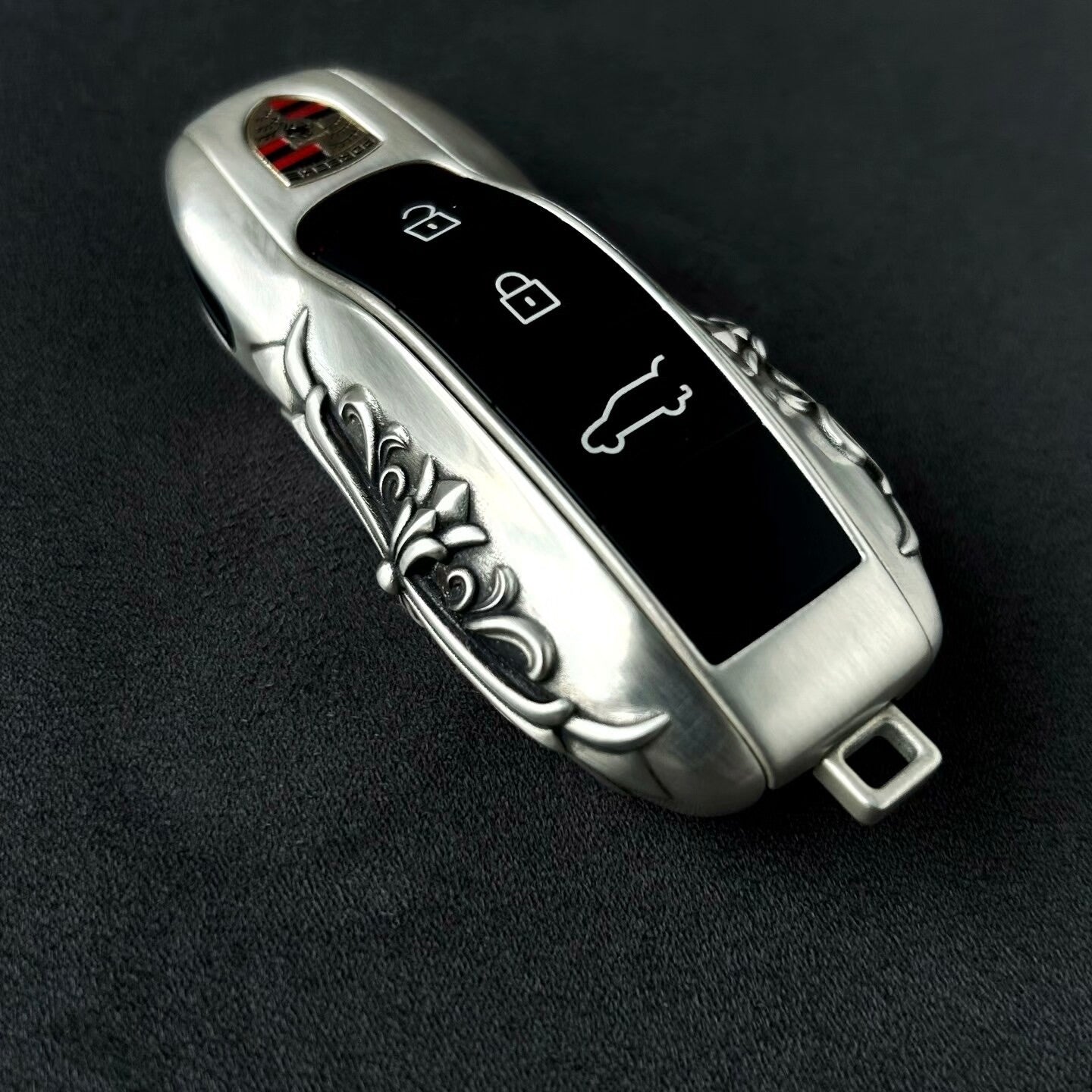 Sterling Silver Porsche key case displayed with understated elegance on dark surface