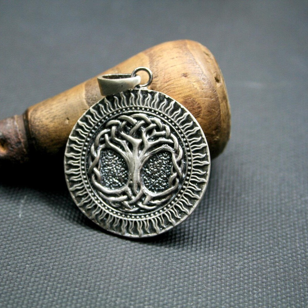Tree of Life 925 Silver Sun Pendant, held for scale